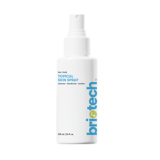 A minimalist white 100 ml spray bottle labeled Topical Skin Spray with blue and gray text, designed to cleanse, deodorize, and calm skin irritation on face and body.